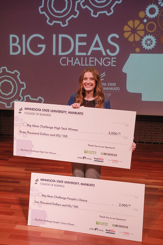 a person holding a large check