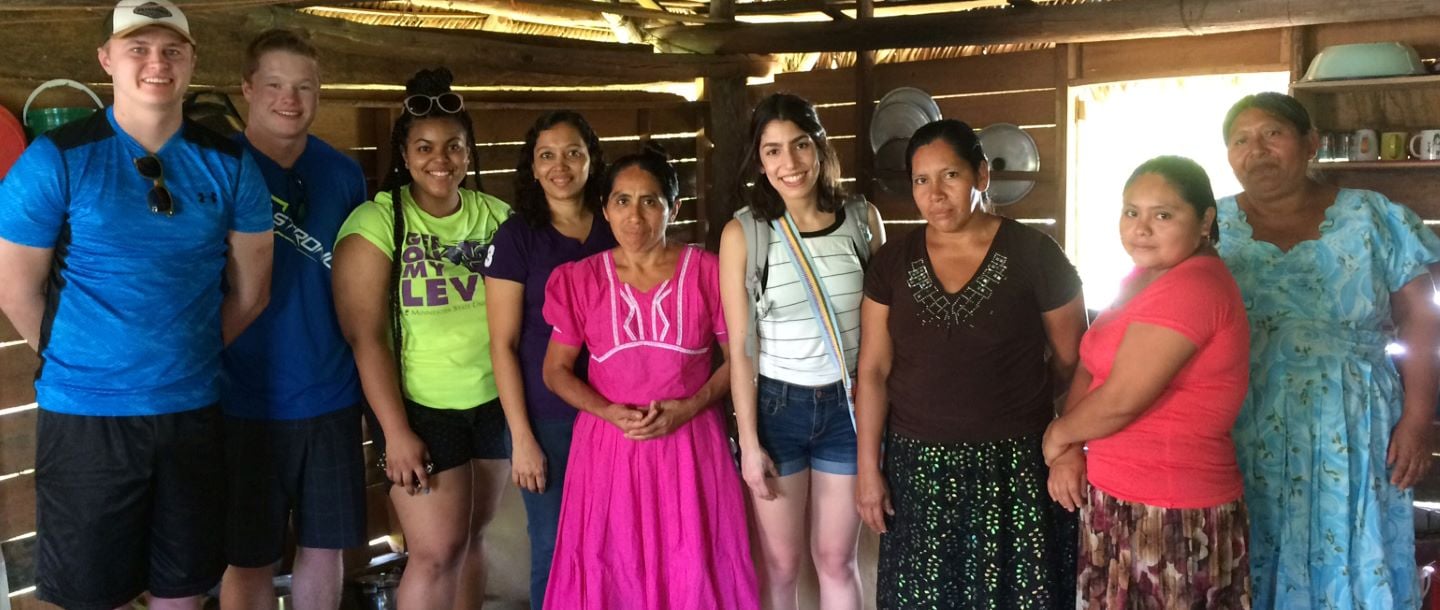 Five Minnesota State University students with Belize natives in their home
