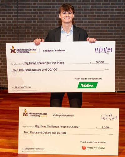 Carter Schuurmans posing with his Big Ideas Challenge awards