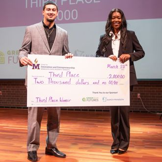 Gustavus Adolphus College Business Track student winners posing for a group photo with a giant check at the 2025 FutureSolvers Cultivation Challenge for third place AgriPath Trade Academy