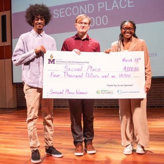 Minnesota State University, Mankato STEM Track and People’s Choice student winners posing for a group photo with a giant check at the 2025 FutureSolvers Cultivation Challenge for second place LoRaNET