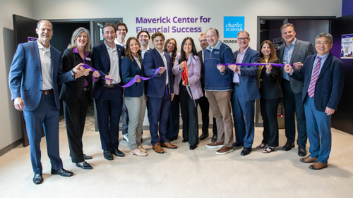 Faculty, staff and students standing in front of the Charles Schwab Foundation Center for Financial Wellness center for the ribbon cutting ceremony event