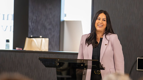 Sherri Trombley giving a speech at the Inaugural Conference of the Maverick Center for Financial Success event