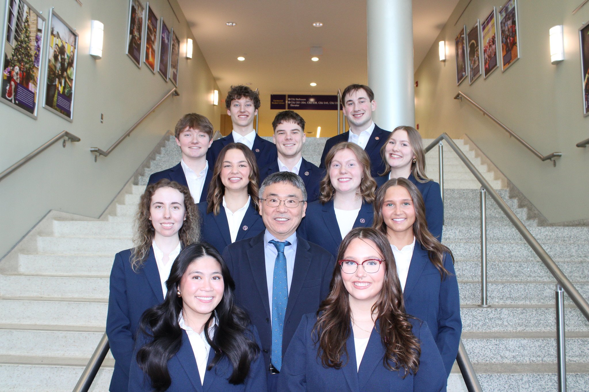 The 2024-2025 Student Executive Team posing on a staircase for a group photo