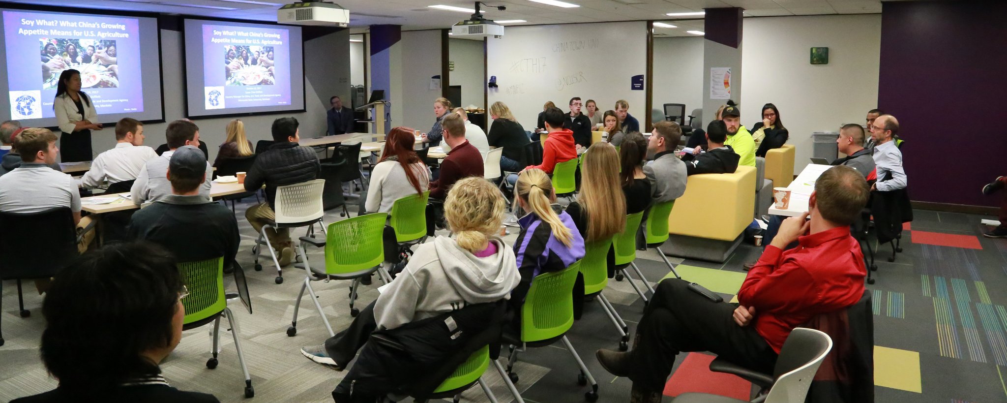 a group of people sitting in chairs in a room