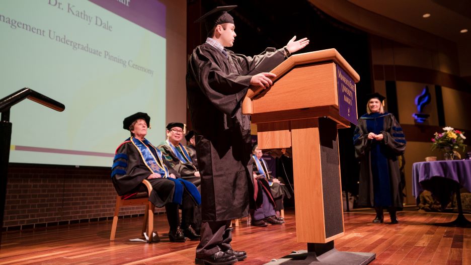 COB student giving speech in podium in Graduation Ceremony Spring 2021