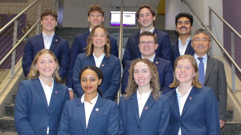 The 2024-2025 Student Executive Team posing on a staircase for a group photo