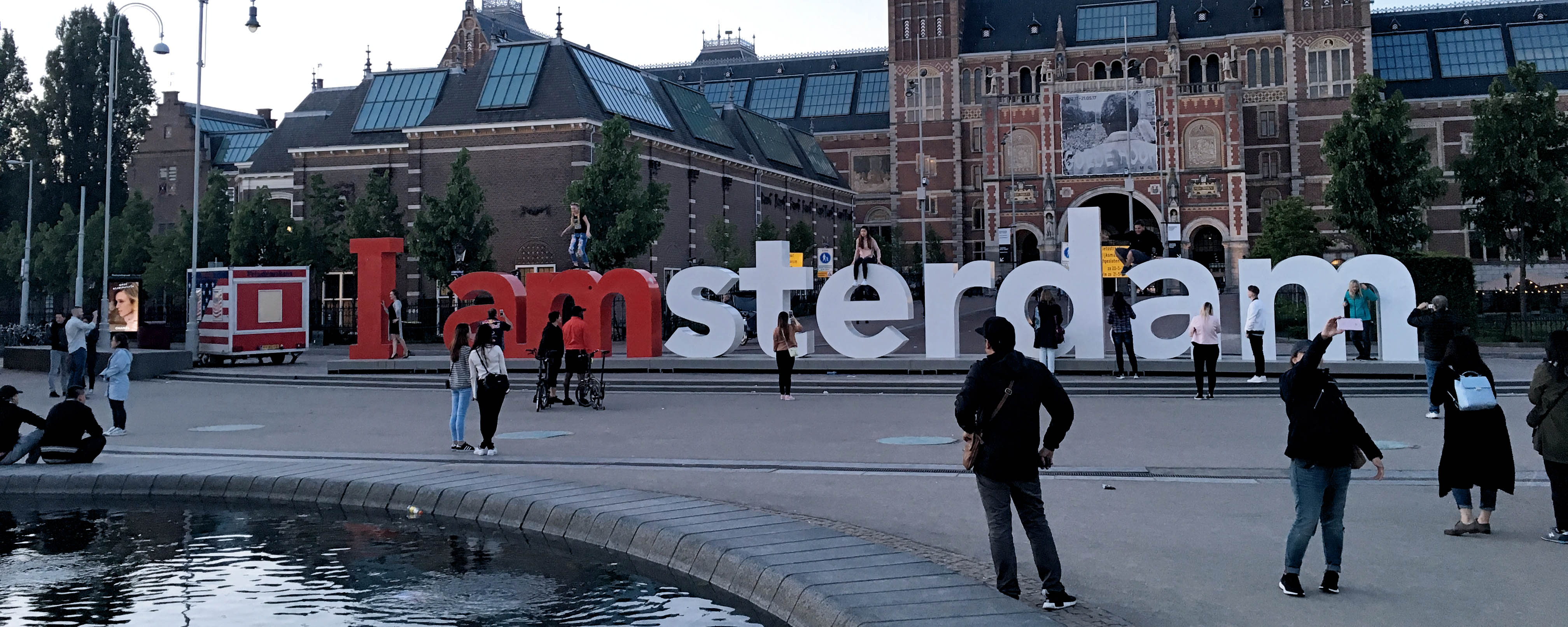 People taking pictures around and on top of 'I amsterdam' sign in Museumplein, The Netherlands