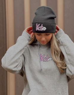 A person posing with a Kato Kozy hoodie and sweatshirt