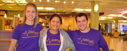 a group of people in purple shirts