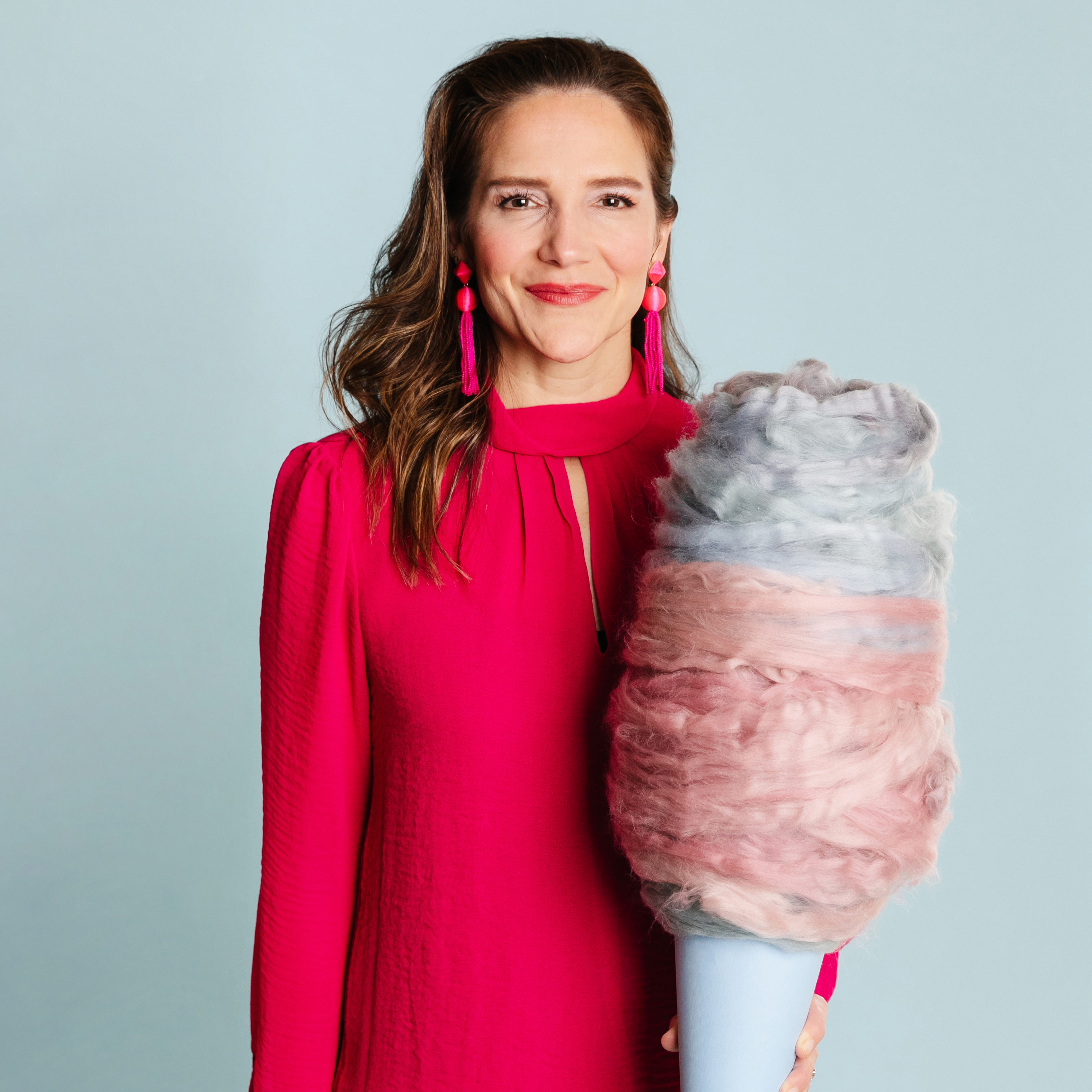 a person holding a cotton candy